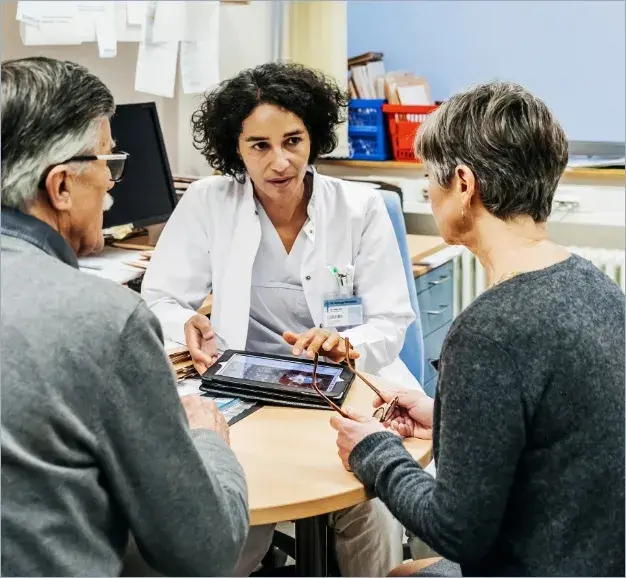 Doctor consulting with patient and care partner