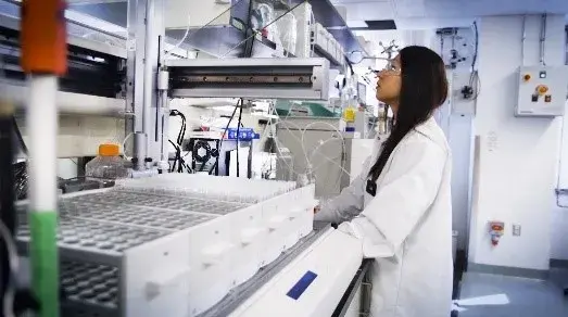 Scientist in laboratory working at a bench